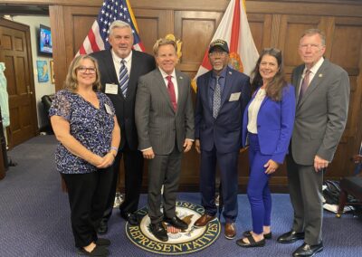 A group pose for a picture with Simeon Fowler and Florida Congressman Mike Haridopolos during the 2025 Grassroots Conference