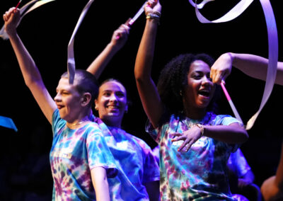 Smiling Astronaut High School students wearing tie dyed shirts twirling dance ribbons at the BAC 12th Annual Performing Arts Showcase at the King Center in Melbourne.