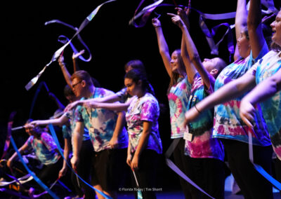 Astronaut High School students wearing tie dyed shirts twirling dance ribbons at the BAC 12th Annual Performing Arts Showcase at the King Center in Melbourne.