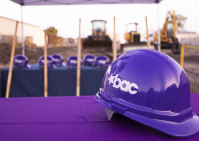 Hard hat with BAC logo on a purple table
