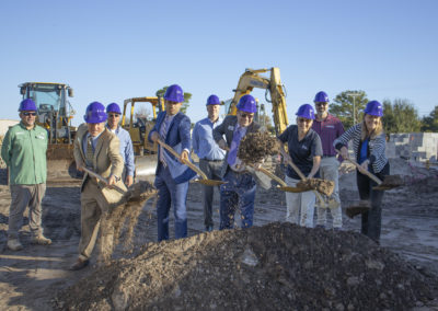 Executives with shovels at a groundbreaking ceremony