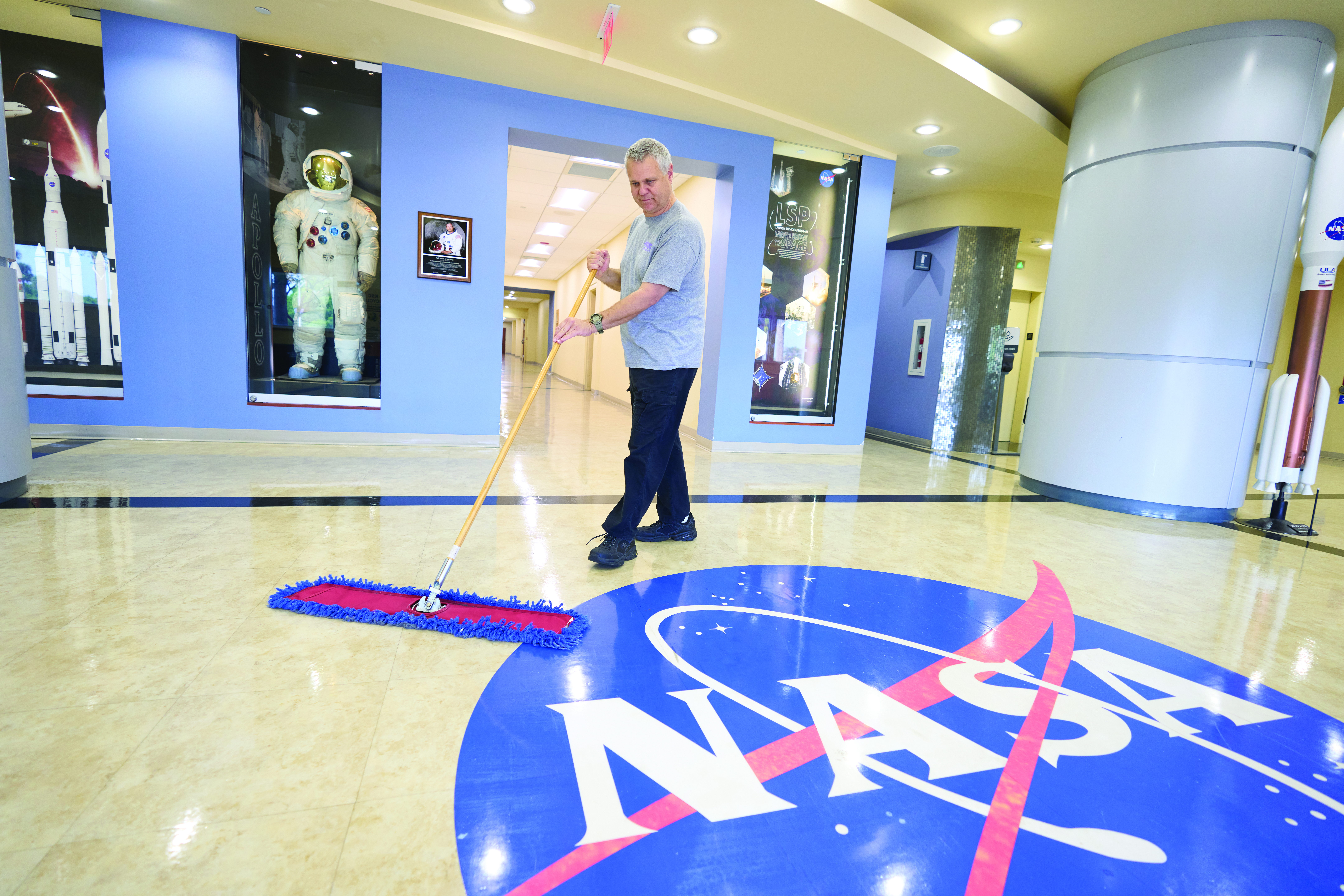 BAC_SourceAmerica_NASA_KSC_April2023_037 BAC worker sweeping a floor at NASA KSC