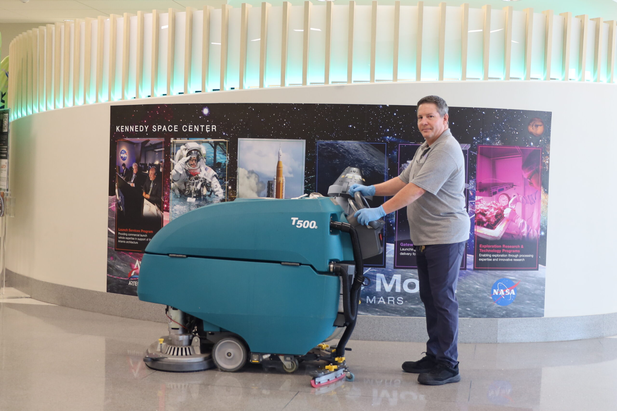 BAC employee running an autoscrubber at Kennedy Space Center