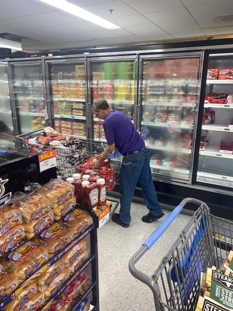 Nathan Yates stocking shelves at Hurlburt Commissary